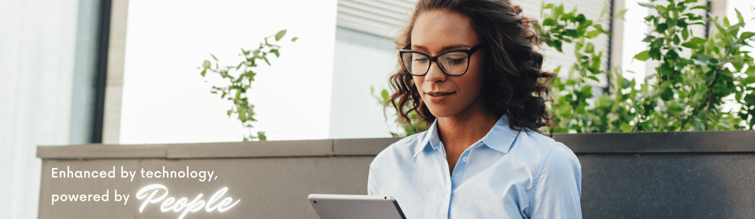 Woman using tablet outdoors — Adwella’s people-powered, tech-enhanced approach to marketing.